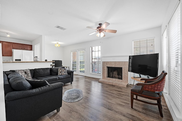 2211 S Kirkwood Rd Unit 26, Houston, TX 77077 - living room featuring ceiling fan, wood finished floors, and a tiled fireplace