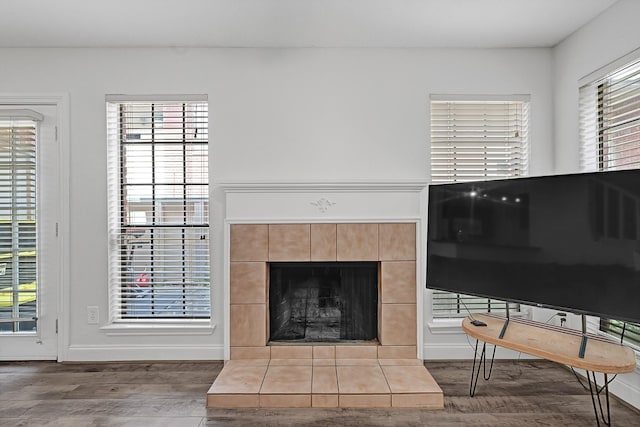 2211 S Kirkwood Rd Unit 26, Houston, TX 77077 - living area with wood finished floors, plenty of natural light, a tile fireplace, and baseboards