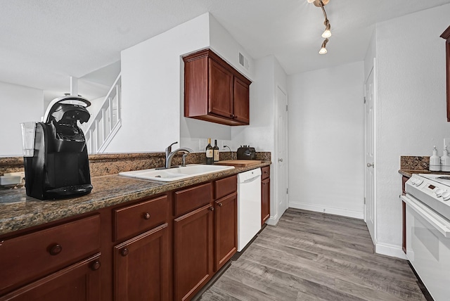 2211 S Kirkwood Rd Unit 26, Houston, TX 77077 - kitchen with white appliances, a sink, light wood-type flooring, baseboards, and dark stone counters