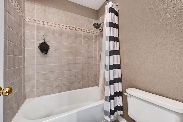 2211 S Kirkwood Rd Unit 26, Houston, TX 77077 - bathroom with toilet, shower / bath combination with curtain, and a textured wall