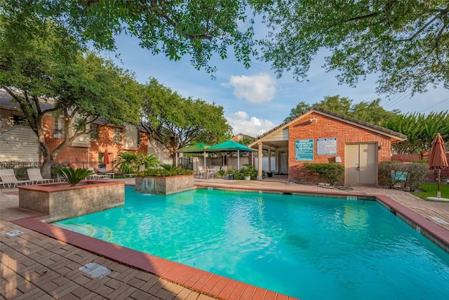 2211 S Kirkwood Rd Unit 26, Houston, TX 77077 - community pool with a patio and an outbuilding
