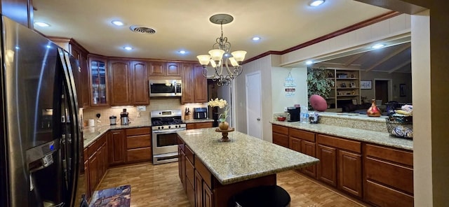 1 Lazy Ln, Bay City, TX 77414 - kitchen with stainless steel appliances, a chandelier, tasteful backsplash, crown molding, and glass insert cabinets
