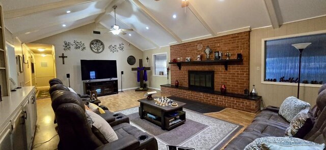 1 Lazy Ln, Bay City, TX 77414 - living room featuring ceiling fan, beamed ceiling, a brick fireplace, high vaulted ceiling, and baseboards