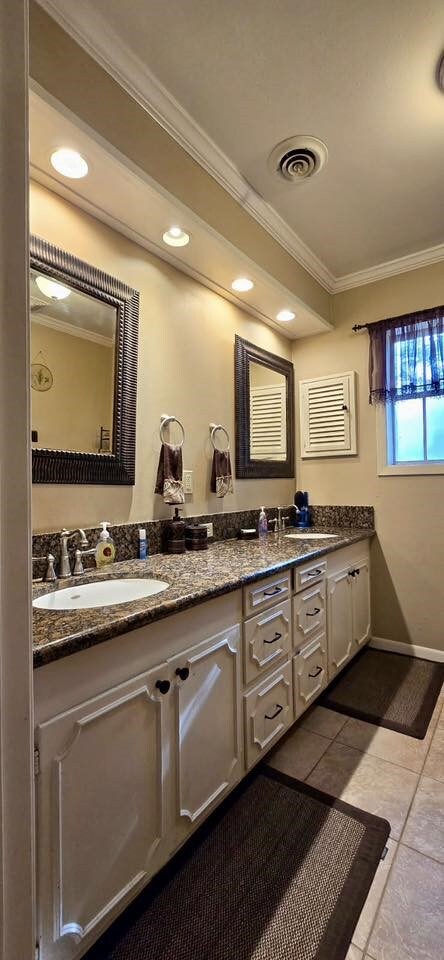 1 Lazy Ln, Bay City, TX 77414 - bathroom with ornamental molding, double vanity, tile patterned flooring, baseboards, and recessed lighting