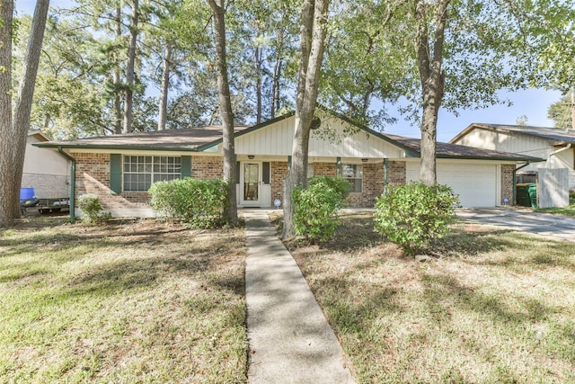 1805 Twila Ln, Conroe, TX 77301 - view of front of home with brick siding, an attached garage, and a front lawn