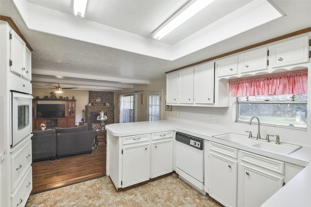 1805 Twila Ln, Conroe, TX 77301 - kitchen with white appliances, a sink, open floor plan, white cabinetry, and light countertops