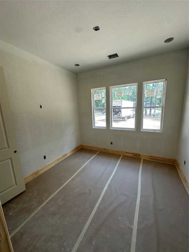 2439 Centurian Cir, Roman Forest, TX 77357 - empty room with a textured ceiling and baseboards