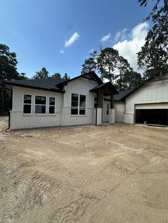 2439 Centurian Cir, Roman Forest, TX 77357 - view of front of property featuring driveway, board and batten siding, and brick siding