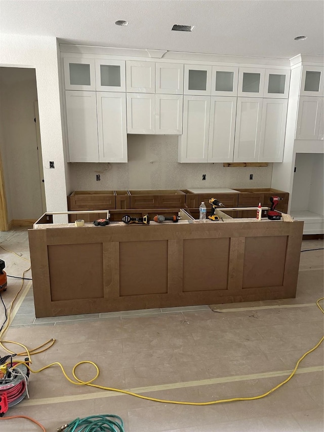 2439 Centurian Cir, Roman Forest, TX 77357 - kitchen with white cabinets and glass insert cabinets