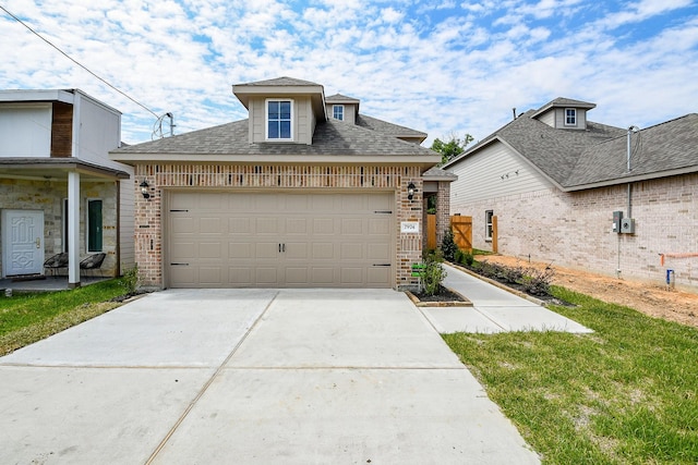 7974 Fowlie St, Houston, TX 77028 - view of front of home featuring brick siding, an attached garage, concrete driveway, and roof with shingles