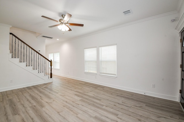 7974 Fowlie St, Houston, TX 77028 - unfurnished living room with a ceiling fan, wood finished floors, crown molding, baseboards, and stairway