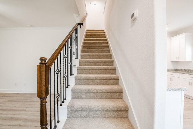 7974 Fowlie St, Houston, TX 77028 - staircase with wood finished floors, crown molding, and baseboards