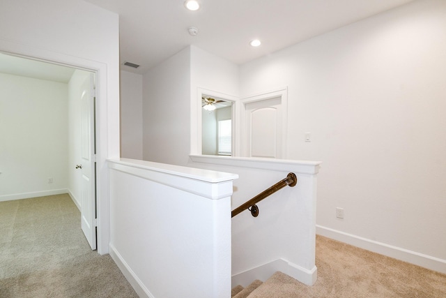 7974 Fowlie St, Houston, TX 77028 - hallway featuring light carpet, an upstairs landing, baseboards, and recessed lighting