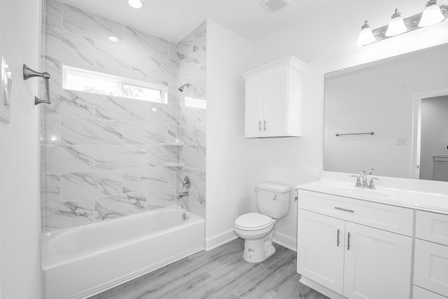7974 Fowlie St, Houston, TX 77028 - full bathroom featuring vanity, shower / bath combination, toilet, wood finished floors, and recessed lighting