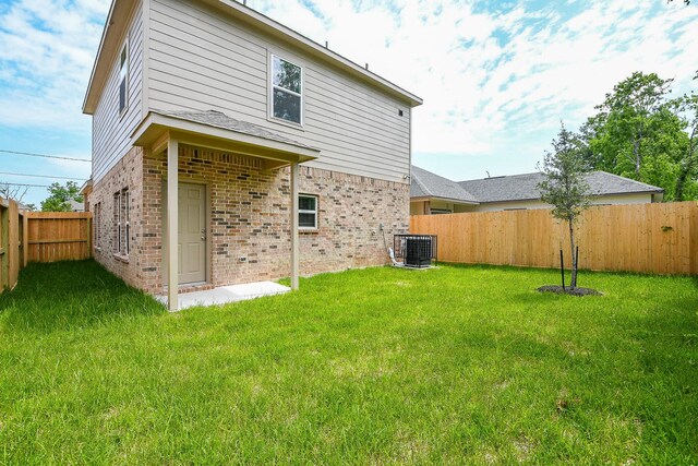7974 Fowlie St, Houston, TX 77028 - rear view of house featuring brick siding and cooling unit