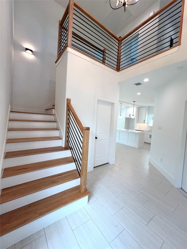 7107 Foster St Unit A, Houston, TX 77021 - stairway with a towering ceiling and wood finished floors