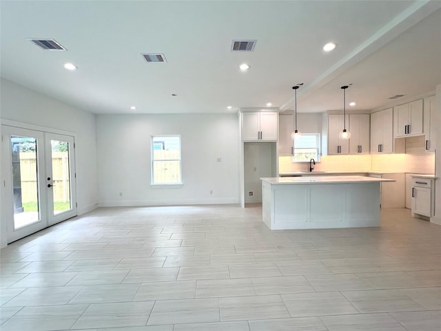 7107 Foster St Unit A, Houston, TX 77021 - kitchen with healthy amount of natural light, recessed lighting, a kitchen island, white cabinetry, and open floor plan
