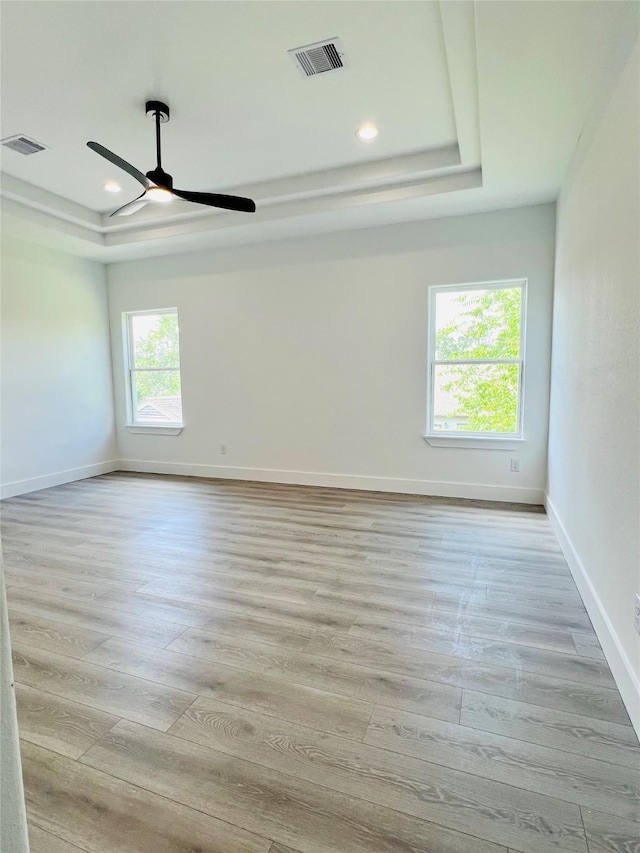 7107 Foster St Unit A, Houston, TX 77021 - unfurnished room with a raised ceiling, light wood-type flooring, a ceiling fan, and recessed lighting