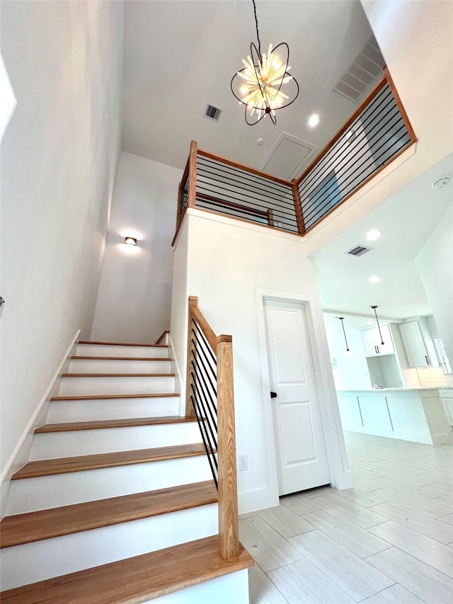7107 Foster St Unit A, Houston, TX 77021 - stairs with a towering ceiling, a chandelier, and recessed lighting