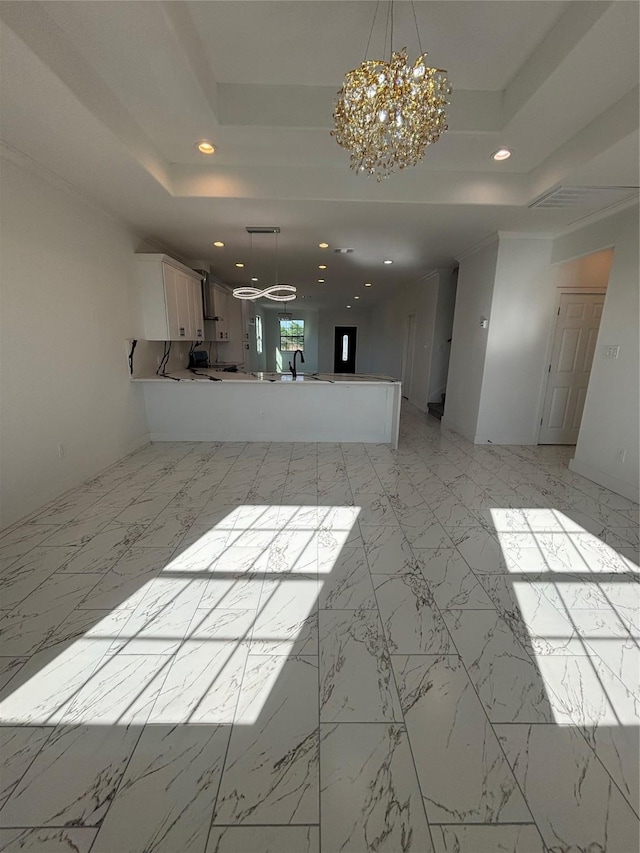 6197 Rd 5503, Cleveland, TX 77327 - unfurnished living room featuring a raised ceiling, a chandelier, recessed lighting, light marble finish floors, and a sink