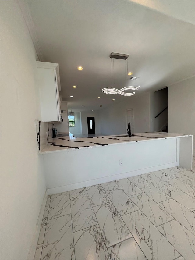 6197 Rd 5503, Cleveland, TX 77327 - kitchen with white cabinetry, marble look tile flooring, recessed lighting, baseboards, and hanging light fixtures