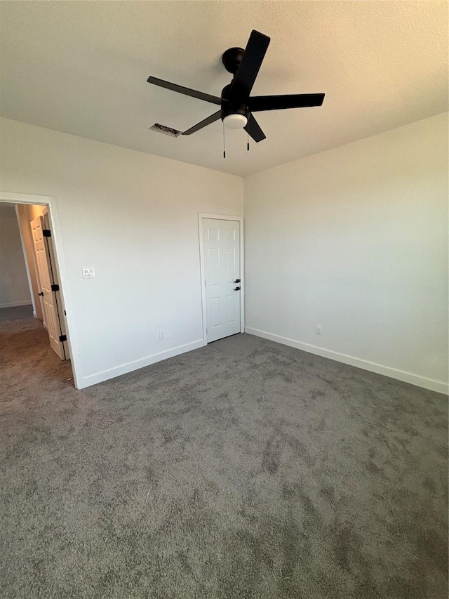 6197 Rd 5503, Cleveland, TX 77327 - spare room featuring a ceiling fan, dark carpet, and baseboards