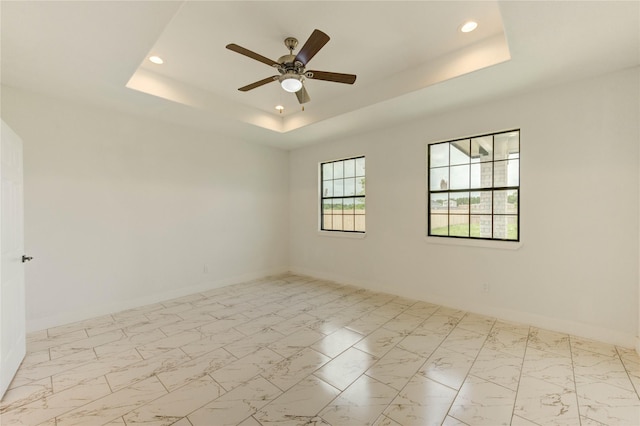6197 Rd 5503, Cleveland, TX 77327 - unfurnished room with a raised ceiling, recessed lighting, baseboards, a ceiling fan, and marble look tiles
