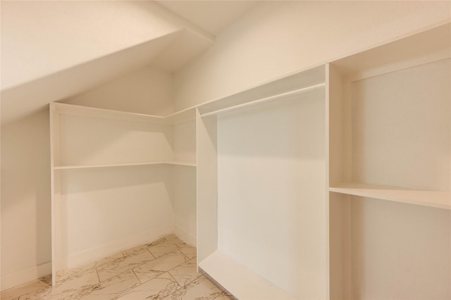6197 Rd 5503, Cleveland, TX 77327 - spacious closet with marble look tile flooring and lofted ceiling