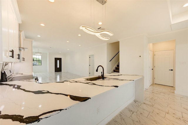 6197 Rd 5503, Cleveland, TX 77327 - kitchen with white cabinets, a sink, light stone counters, recessed lighting, and pendant lighting
