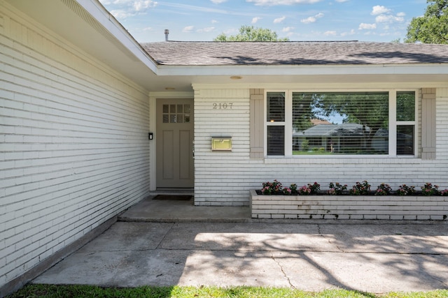 2107 Hewitt Dr, Houston, TX 77018 - doorway to property with brick siding and roof with shingles