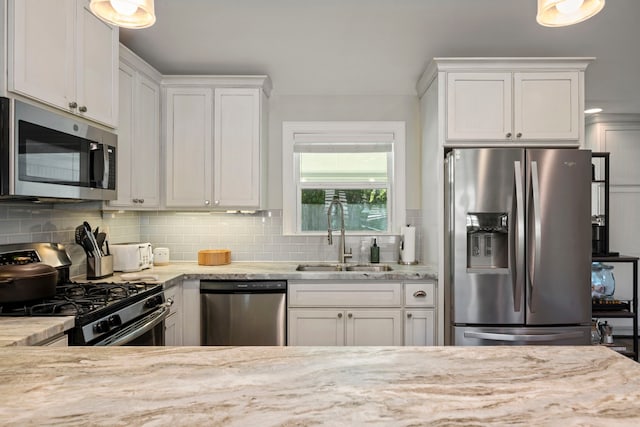 2107 Hewitt Dr, Houston, TX 77018 - kitchen with stainless steel appliances, a sink, backsplash, white cabinets, and light stone countertops