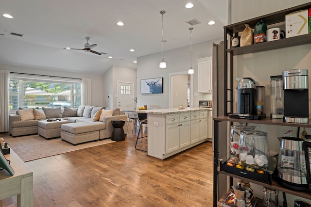 2107 Hewitt Dr, Houston, TX 77018 - living room with plenty of natural light, light wood-type flooring, ceiling fan, recessed lighting, and lofted ceiling