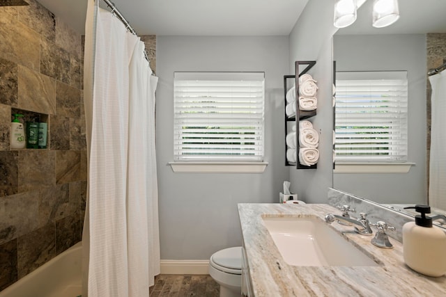 2107 Hewitt Dr, Houston, TX 77018 - full bathroom with toilet, vanity, shower / tub combo with curtain, wood finished floors, and baseboards