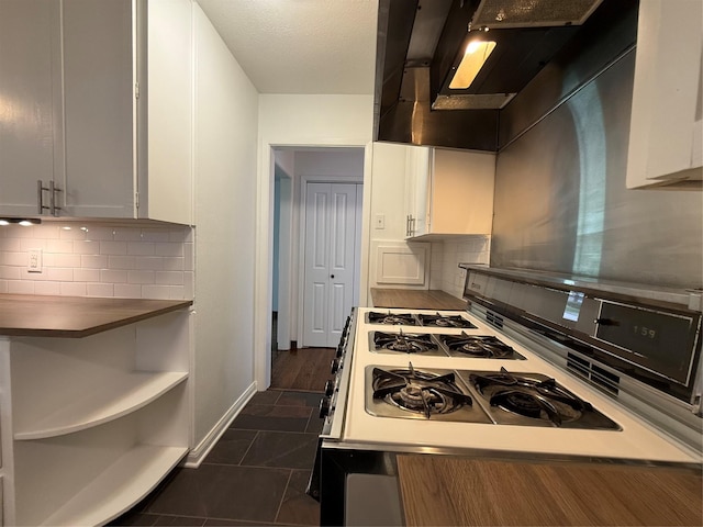2016 N Tinsley St, Angleton, TX 77515 - kitchen featuring range with gas cooktop, extractor fan, backsplash, and white cabinetry