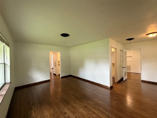 2016 N Tinsley St, Angleton, TX 77515 - spare room featuring dark wood-type flooring and baseboards
