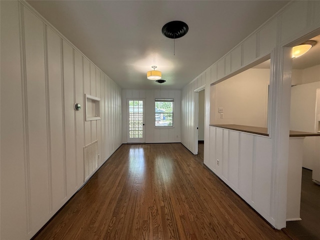 2016 N Tinsley St, Angleton, TX 77515 - unfurnished dining area featuring dark wood-type flooring and a decorative wall
