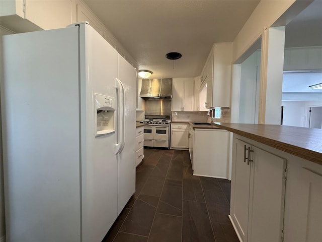 2016 N Tinsley St, Angleton, TX 77515 - kitchen with white refrigerator with ice dispenser, double oven range, wall chimney range hood, a sink, and white cabinets