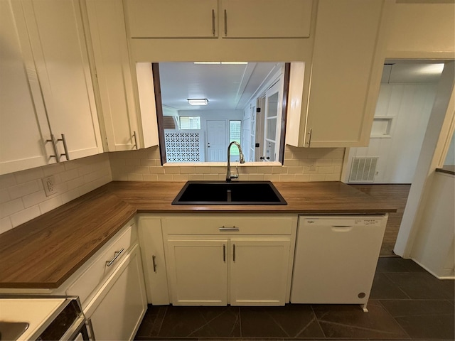 2016 N Tinsley St, Angleton, TX 77515 - kitchen with dishwasher, a sink, tasteful backsplash, white cabinets, and butcher block countertops