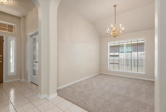 30 Teak Mill Pl, The Woodlands, TX 77382 - carpeted foyer featuring plenty of natural light, tile patterned flooring, a chandelier, arched walkways, and vaulted ceiling