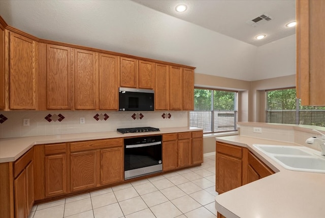 30 Teak Mill Pl, The Woodlands, TX 77382 - kitchen with wall oven, a sink, decorative backsplash, black gas cooktop, and lofted ceiling