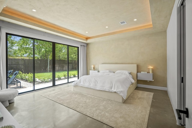 11736 Canyon Ct, Conroe, TX 77385 - bedroom featuring finished concrete floors, access to exterior, a raised ceiling, recessed lighting, and baseboards