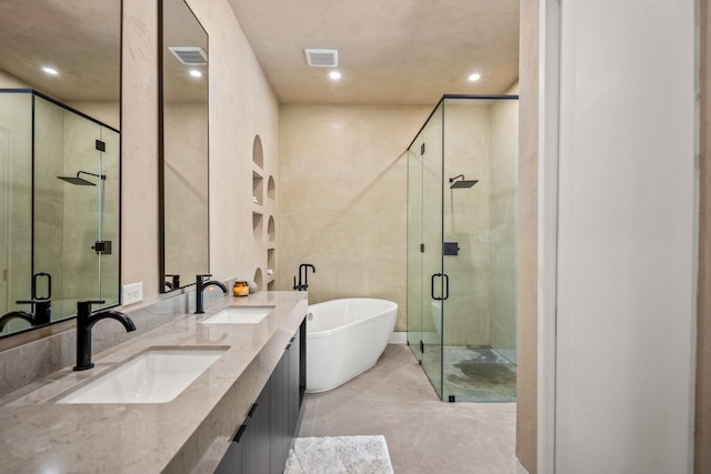 11736 Canyon Ct, Conroe, TX 77385 - bathroom with a soaking tub, double vanity, a shower stall, concrete flooring, and recessed lighting