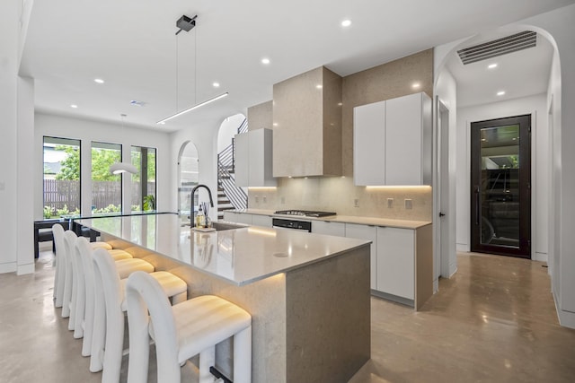 11736 Canyon Ct, Conroe, TX 77385 - kitchen with modern cabinets, a sink, finished concrete floors, tasteful backsplash, and white cabinetry