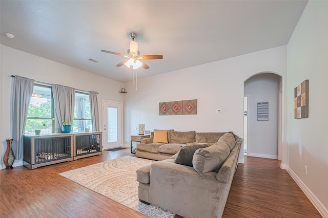 723 Hinsdale, Magnolia, TX 77354 - living area with arched walkways, wood finished floors, baseboards, and ceiling fan