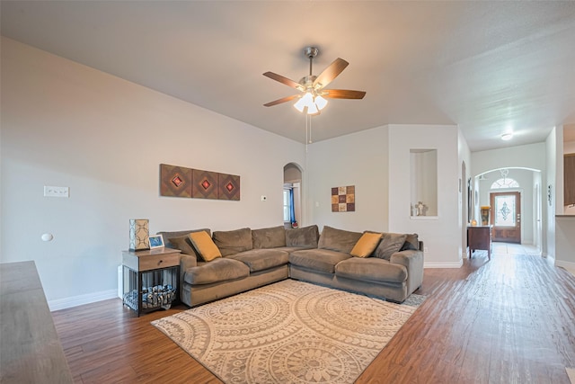 723 Hinsdale, Magnolia, TX 77354 - living room featuring arched walkways, wood finished floors, ceiling fan, and baseboards