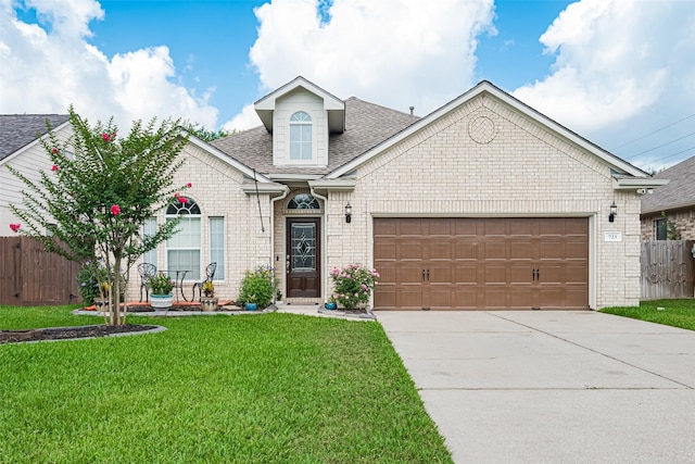 723 Hinsdale, Magnolia, TX 77354 - view of front of house featuring an attached garage, roof with shingles, driveway, and brick siding