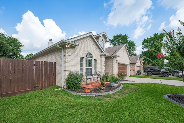 723 Hinsdale, Magnolia, TX 77354 - view of side of home featuring brick siding, a chimney, an attached garage, and concrete driveway