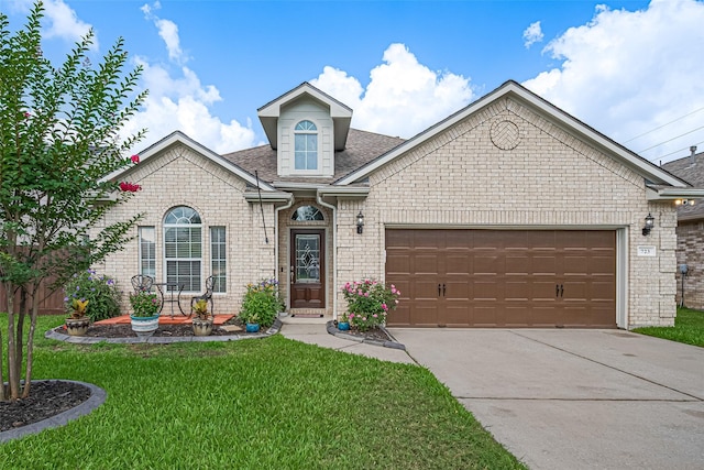 723 Hinsdale, Magnolia, TX 77354 - traditional home featuring a front yard, concrete driveway, an attached garage, a shingled roof, and brick siding