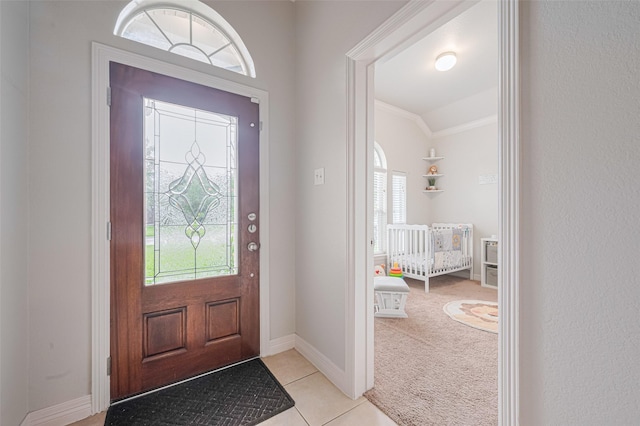 723 Hinsdale, Magnolia, TX 77354 - entryway featuring healthy amount of natural light, ornamental molding, light colored carpet, light tile patterned floors, and baseboards