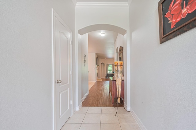 723 Hinsdale, Magnolia, TX 77354 - corridor featuring arched walkways, light tile patterned floors, baseboards, and crown molding